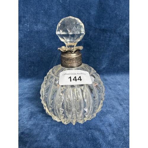 144 - A cut glass perfume bottle with glass stopper and silver banding, hallmarked Birmingham