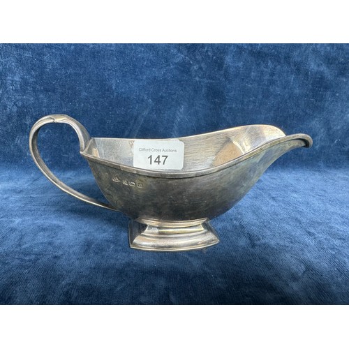 147 - A silver sauceboat of plain design in the art nouveau style, hallmarked Birmingham and marked on bas... 