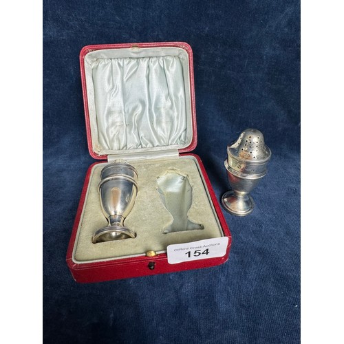 154 - A pair of silver pepperettes in presentation case, hallmarked Chester 1911