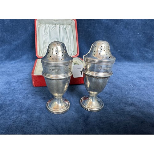 154 - A pair of silver pepperettes in presentation case, hallmarked Chester 1911