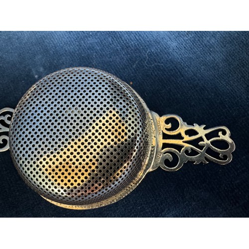 170 - A Silver tea strainer and bowl on 3 feet, both hallmarked Birmingham and marked J.B.C and S