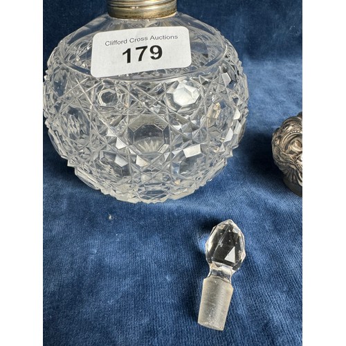 179 - A cut glass scent bottle with glass stopper and silver band and lid, hallmarked (possibly Chester)