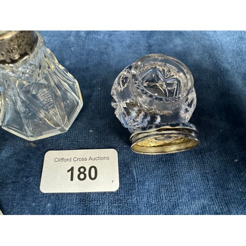 180 - An antique cut glass perfume bottle with silver mount hallmarked Birmingham 1907 and one other with ... 