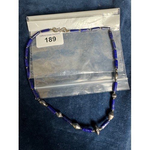 189 - An antique style blue beaded glass necklace with clasp marked S.I.L