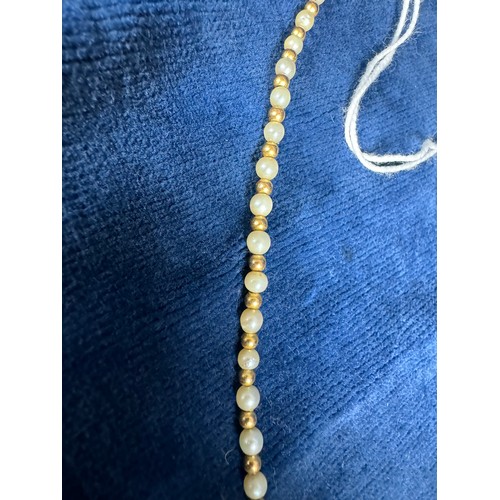 200 - A set of seed pearls interspersed with small gold coloured beads & 9ct gold clasp