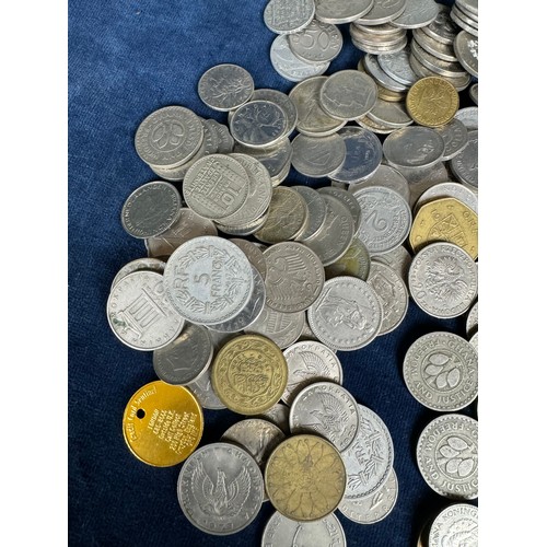 209 - A plastic box containing Ghanaian and other foreign coins, and one other.