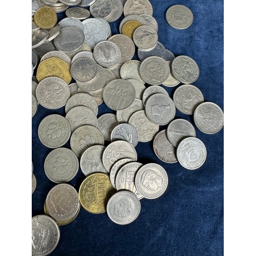 209 - A plastic box containing Ghanaian and other foreign coins, and one other.