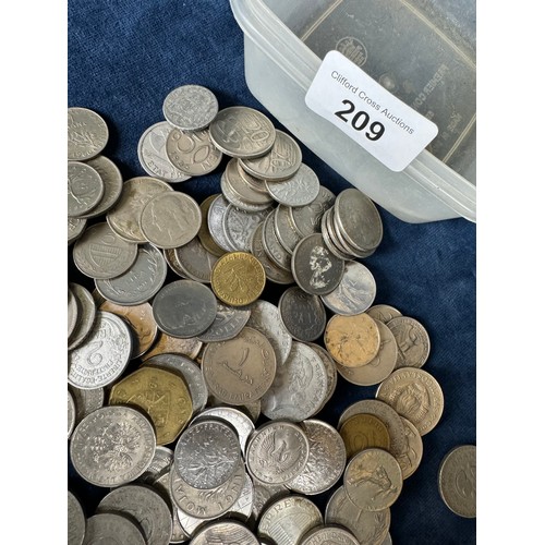 209 - A plastic box containing Ghanaian and other foreign coins, and one other.