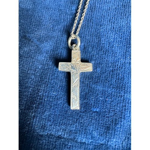 235 - A silver Cross with leaf pattern decoration, hallmarked Chester, on a silver coloured metal chain.