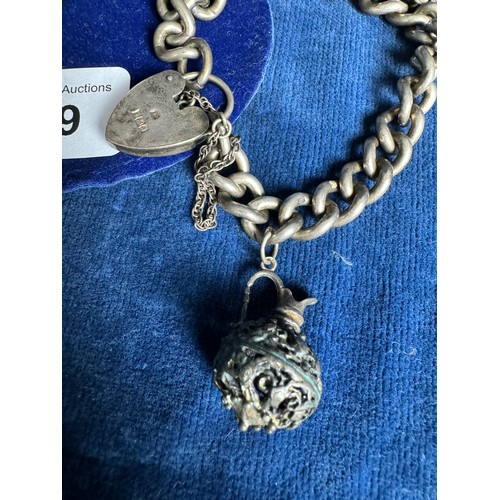 239 - A silver charm bracelet, hallmarked Birmingham, having two metal charms – a Jug and 
