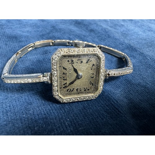 243 - An Art Deco Tiffany & Co platinum and diamond encrusted ladies wrist watch on expanding platinum str... 