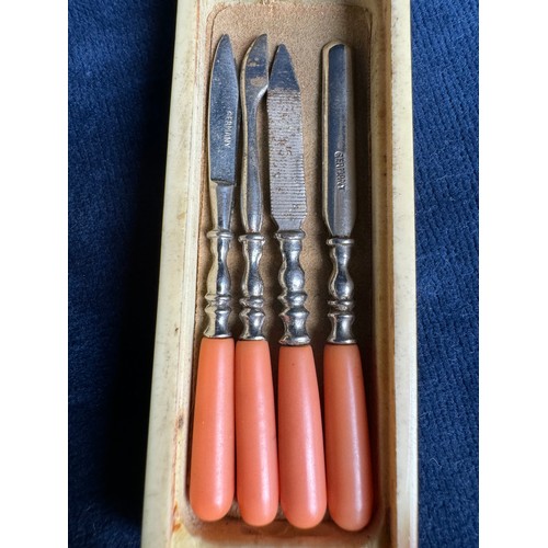 275 - A vintage miniature manicure set with coral handles in original box and marked 