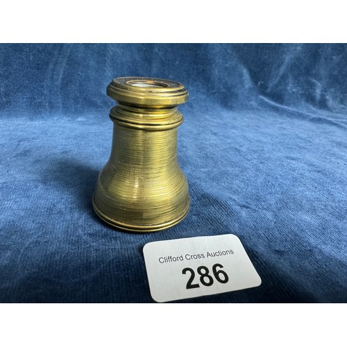 286 - An extendable brass opera glass of plain design marked around eyepiece 