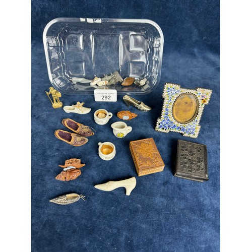 292 - A tub of miniature items including a decorative photo frame, small carved box, wooden match case, sh... 