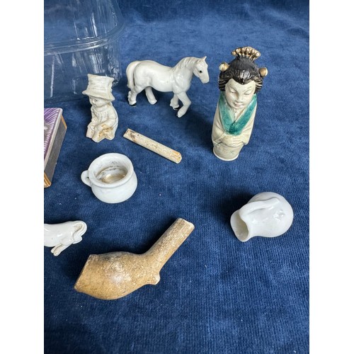 293 - A tub of collectable items including a small toy figure, cotton holders in the shape of girls, horse... 