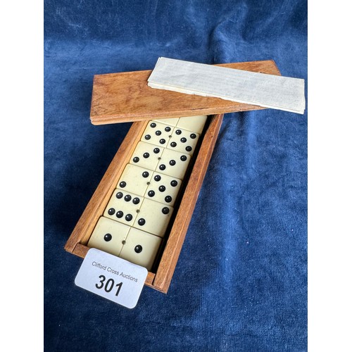 301 - A vintage set of dominoes in wooden box.