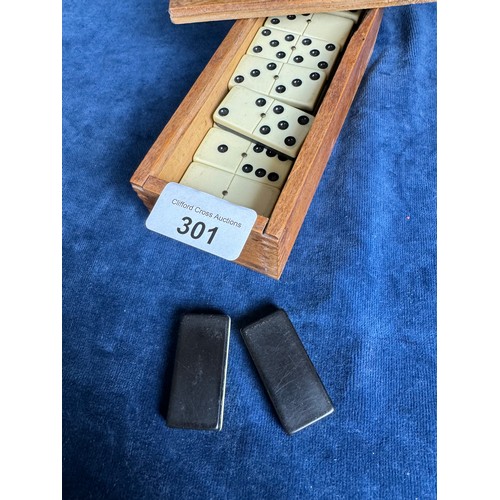 301 - A vintage set of dominoes in wooden box.