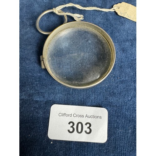 303 - A small metal framed magnifying glass.