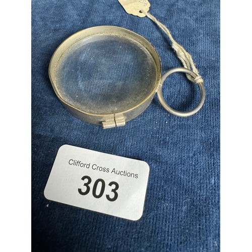 303 - A small metal framed magnifying glass.