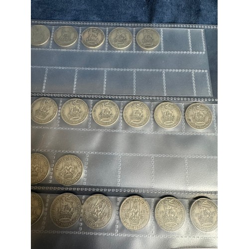 316 - A sheet containing 35 one shilling coins dating 1920 to 1959