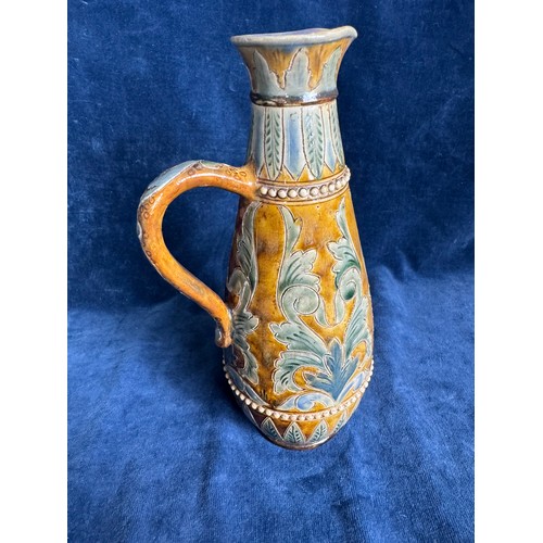 391 - A Royal Doulton Lambeth stoneware art nouveau ewer having brown and blue glaze with leaf and swirl d... 