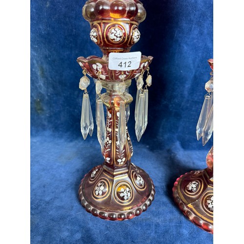 412 - A pair of Baccarat style antique candlesticks with hurricane shades, accented with hand-painted whit... 