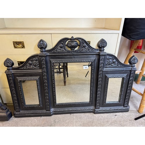 424 - A Victorian cast iron overmantel with mirror having 3 mirrored panels, shaped finials, and urn decor... 