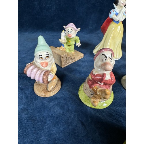 444 - A Royal Doulton set of 8 figures depicting ‘Snow white and the seven dwarves’.