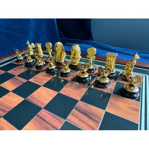 449 - A Franklin Mint 24 ct gold plated embellished Egyptian themed chess set on wooden base with square d... 