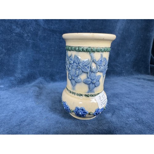 485 - A Royal Doulton Lambeth stoneware glazed vase having beige ground and blue relief floral decoration ... 