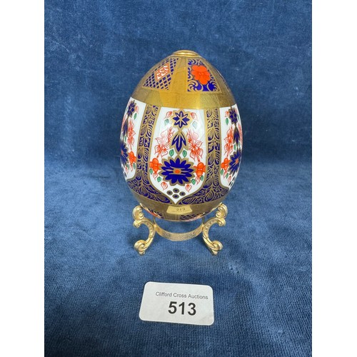 513 - A Royal Crown Derby Egg on gold coloured base having red, blue and gold decoration with gold coloure... 