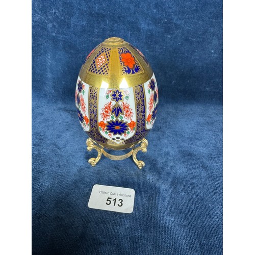 513 - A Royal Crown Derby Egg on gold coloured base having red, blue and gold decoration with gold coloure... 