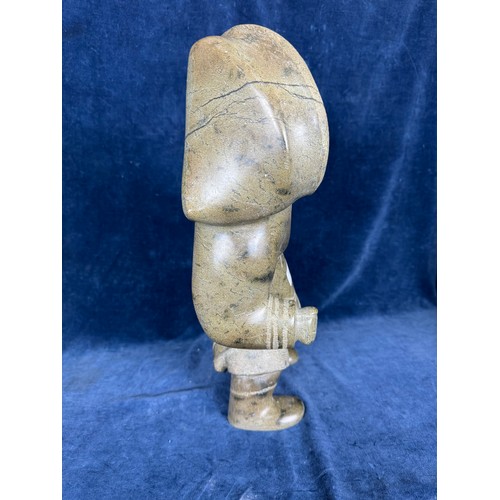 599 - An unusual carved stone figure by Eskimo art, Canada, depicting a
female Inuit character in traditio... 