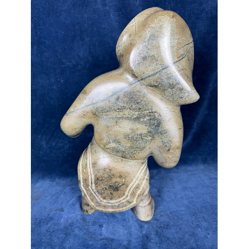 599 - An unusual carved stone figure by Eskimo art, Canada, depicting a
female Inuit character in traditio... 