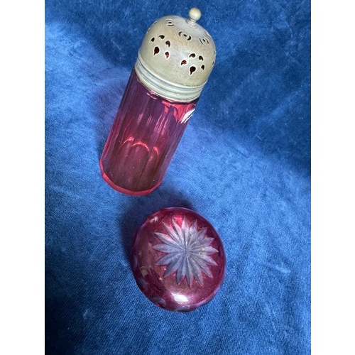 383 - Two pieces of Cranberry Glass comprising a sugar shaker of plain design with metal screw top (chip t... 