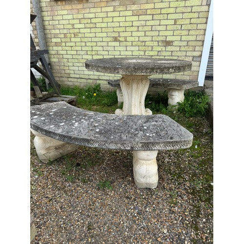 3 - A stone garden table, diameter 114.5cm, with 2 curved benches.