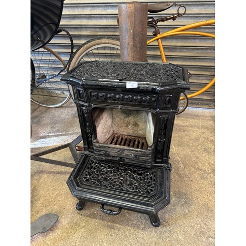 19 - A black enamel Queenie cast iron stove.