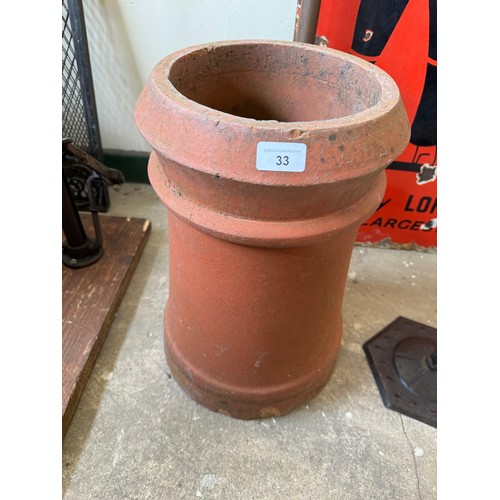 33 - A terracotta chimney pot.