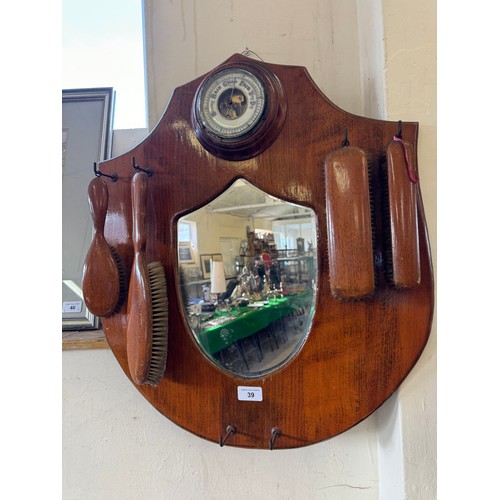 39 - An oak hall mirror with mounted barometer and brushes.