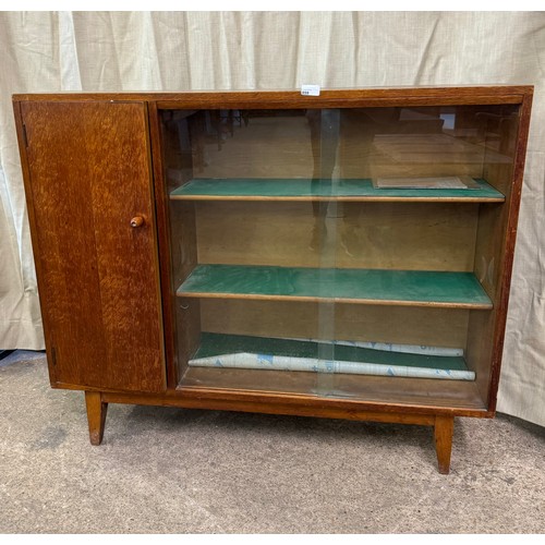 859 - A solid oak bookcase made by Heal & Son Ltd, London having 2 glazed sliding doors with 2 adjustable ... 