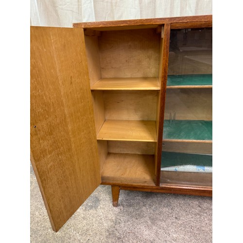 859 - A solid oak bookcase made by Heal & Son Ltd, London having 2 glazed sliding doors with 2 adjustable ... 