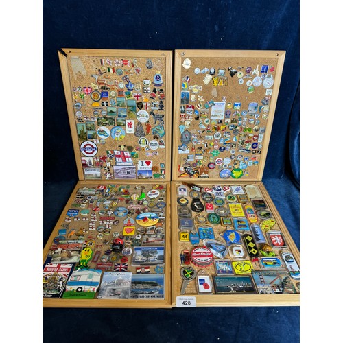 428 - Four cork boards containing a large quantity of pin badges and magnets of various location for UK an... 