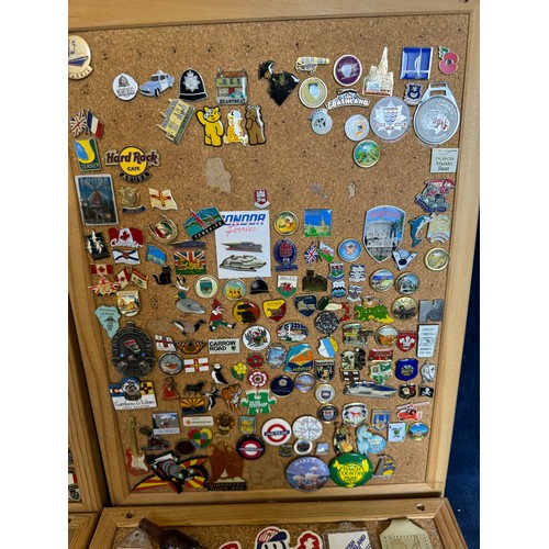 428 - Four cork boards containing a large quantity of pin badges and magnets of various location for UK an... 