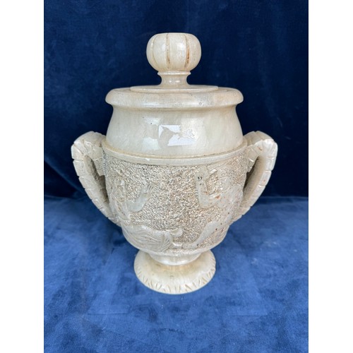 90 - An Alabaster decorative lidded urn with stylised handles and Egyptian figures.