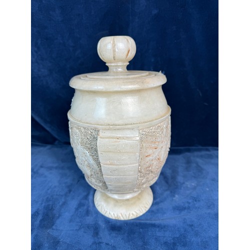 90 - An Alabaster decorative lidded urn with stylised handles and Egyptian figures.