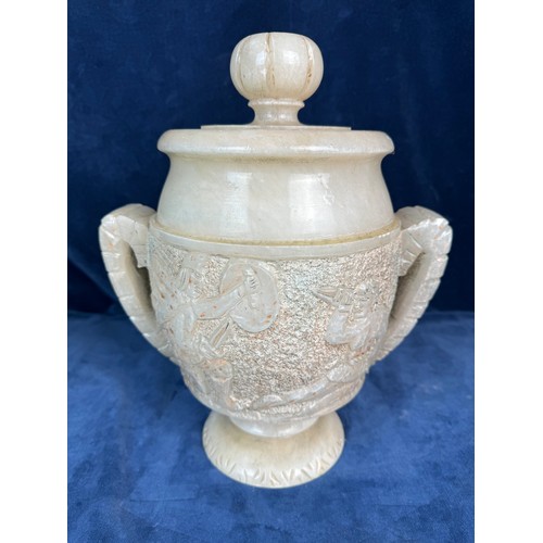 90 - An Alabaster decorative lidded urn with stylised handles and Egyptian figures.