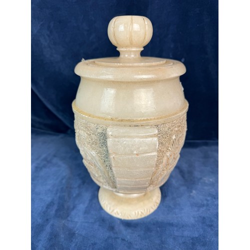 90 - An Alabaster decorative lidded urn with stylised handles and Egyptian figures.