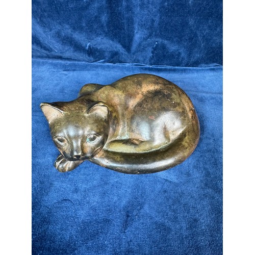 111 - A figure of a cat laying