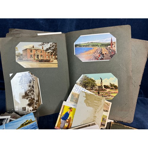 382 - A vintage postcard album containing various black and white and coloured postcards, together with a ... 