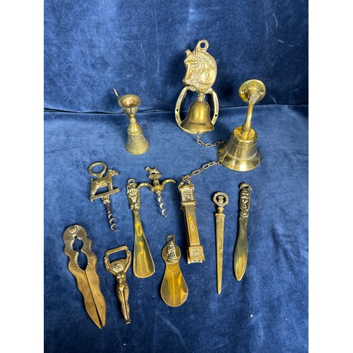 383 - A sundry lot of brassware comprising; mounted horse bell, nutcrackers, corkscrews, shoe horns, etc.,